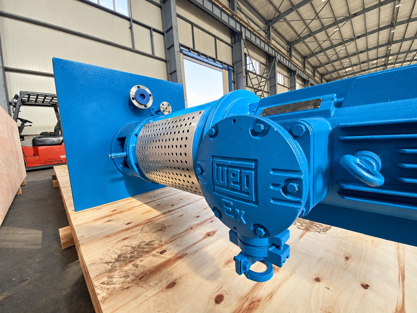 Close view of the blue motor and silver coupling guard.