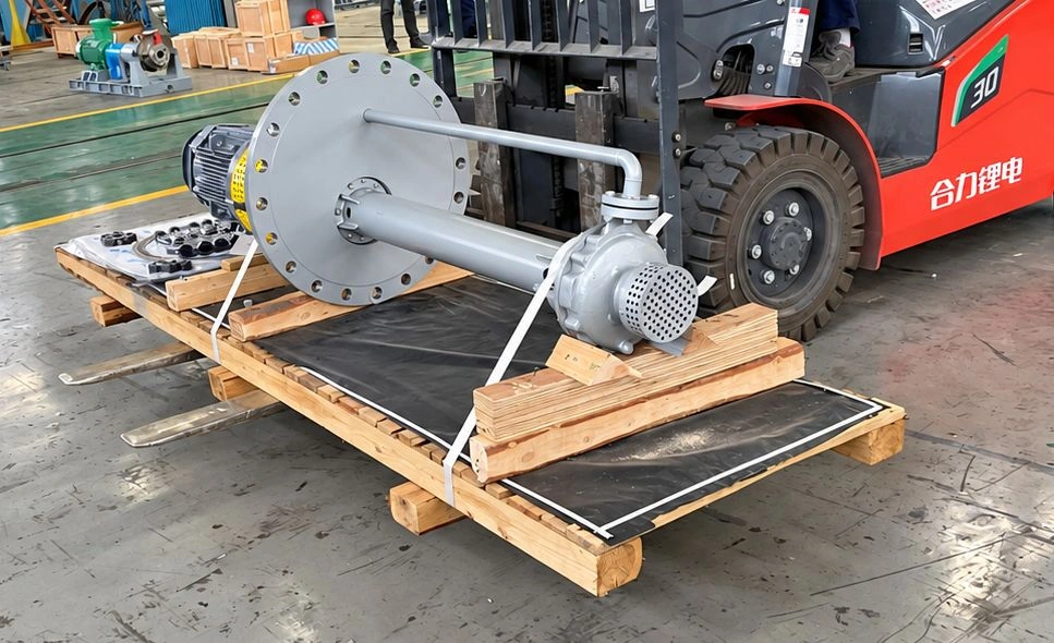 Long-column pump on a transport pallet beside a red forklift.